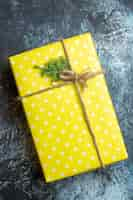 Free photo close up view of beautiful christmas gift box for family member on dark background