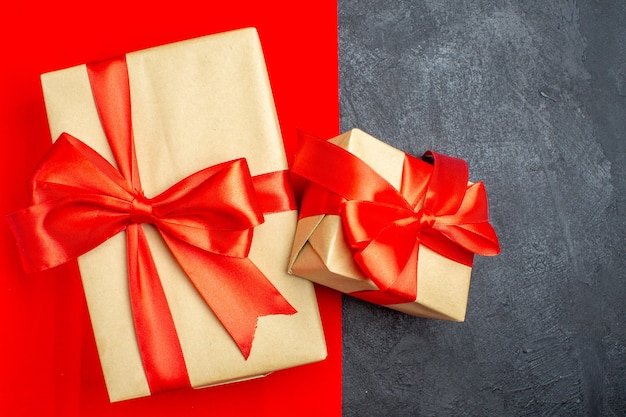 Free photo close up view of beautiful gifts with bow-shaped ribbon on red and black background