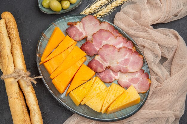 Close up view of best delicious snacks for wine on a towel on a dark background