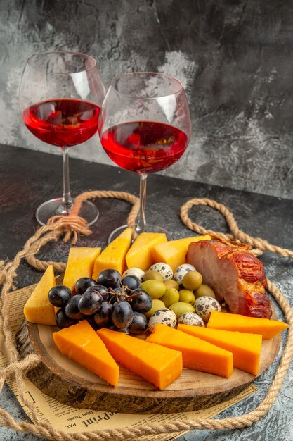 Close up view of best snack with various fruits and foods on a wooden brown tray