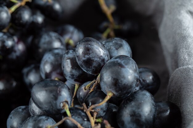 Close up view of black grapes in basket.