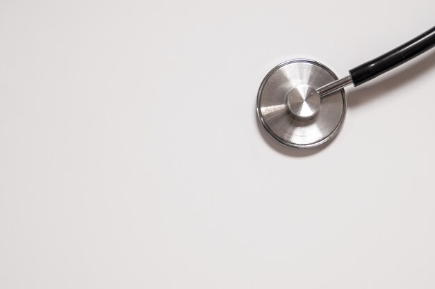 Close up view of black stethoscope on white back