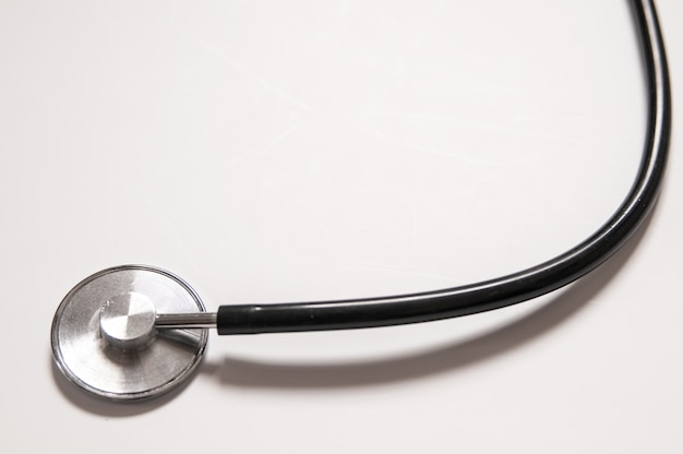 Close up view of black stethoscope on white back