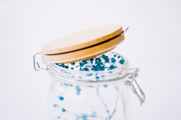 Close up view of blue flowers in glass