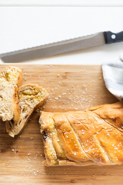 Close-up view of bread on chopper on white table