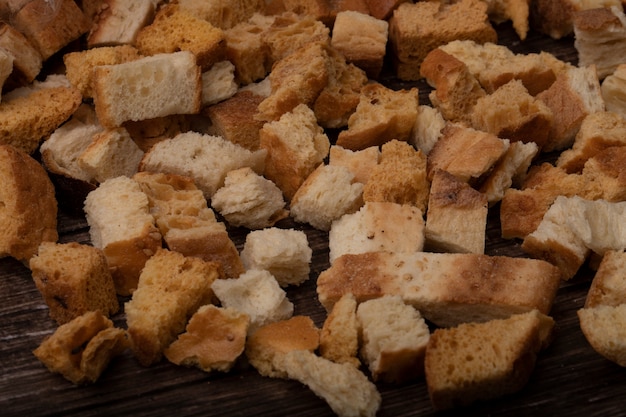 Close-up view of bread pieces on wooden background