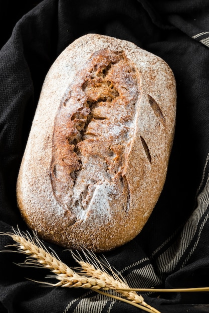 Close-up view of bread and wheat on cloth