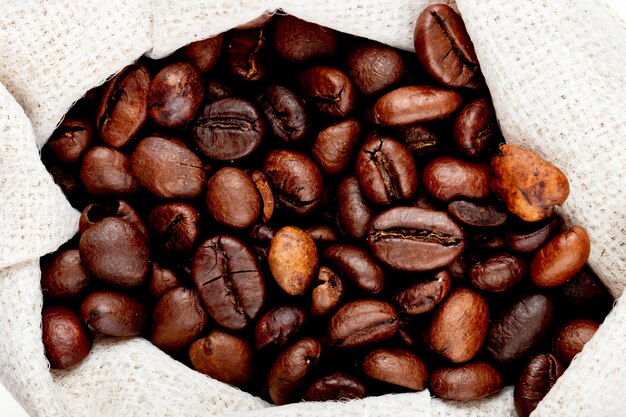 Close up view of brown coffee beans in a sack