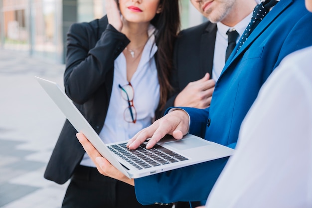 Close up view of business team with laptop