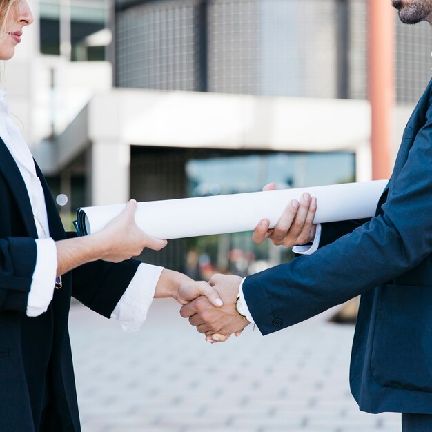 Close up view of businessman and businesswoman shaking hands