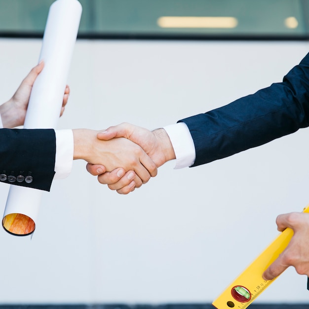 Close up view of businessman and businesswoman shaking hands