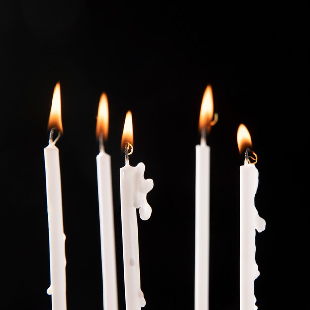 Close-up view of candles with flame arrangement