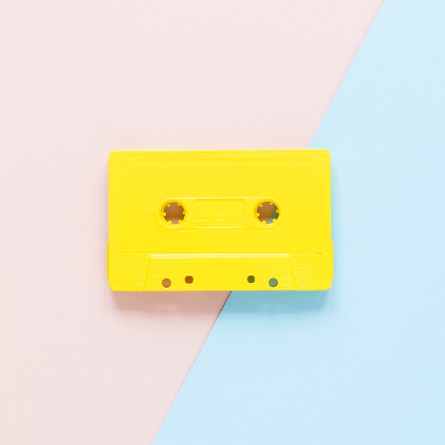 Close-up view of cassette on pink and blue background