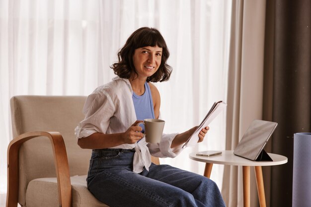 Close up view of caucasian business woman sitting in chair smiling at camera