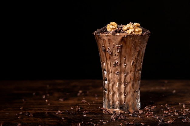 Free photo close-up view of chocolate milkshake with walnuts