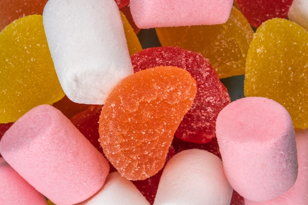 Close up view of colorful tasty marmalade candies and marshmallows