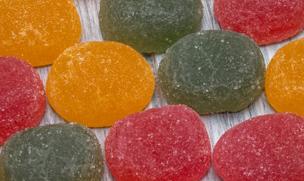 Close up view of colorful tasty marmalade candies scattered on rustic