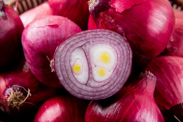 Close-up view of cut red onion and whole red onions