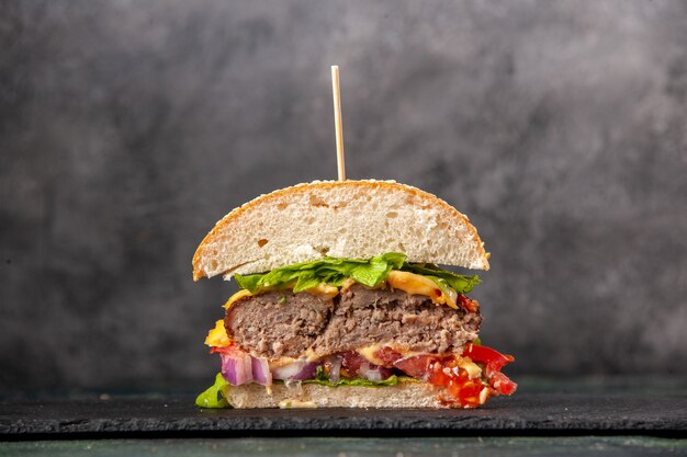 Close up view of cut tasty sandwiches on black tray on dark mix color surface