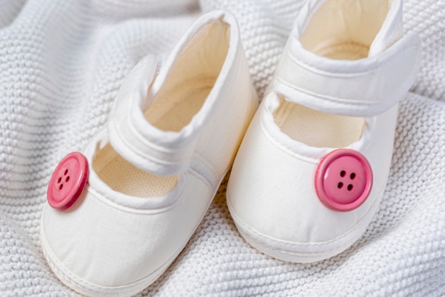 Close-up view of cute little girl shoes on blanket