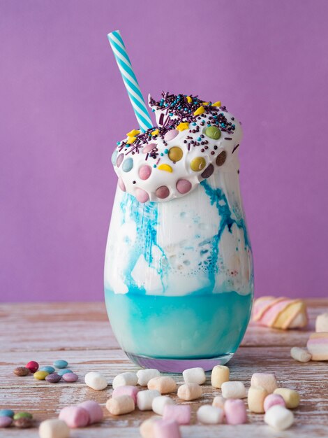 Close-up view of delicious milkshake on wooden table