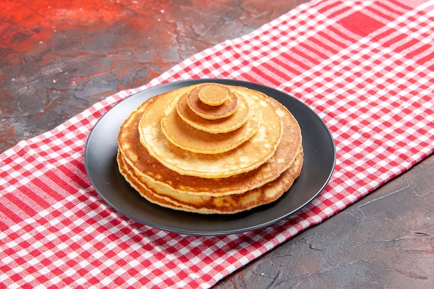 Close up view of delicious panacakes on a red stripped towel