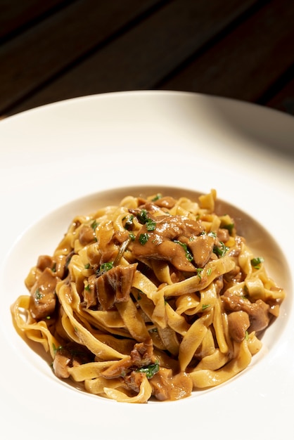 Close-up view of delicious pasta on wooden table