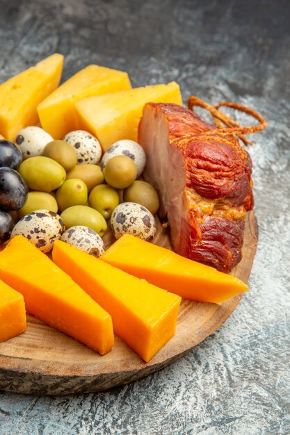 Close up view of delicious snack including fruits and foods on a brown tray on ice background