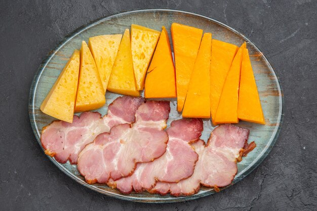 Close up view of delicious snacks on a black background