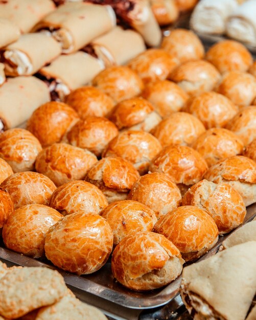 Close up view of delicious sweet pastries on metal dish