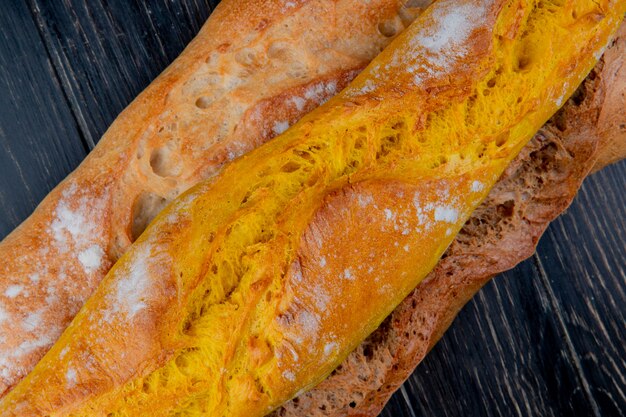 Close-up view of different types of baguette on wooden surface