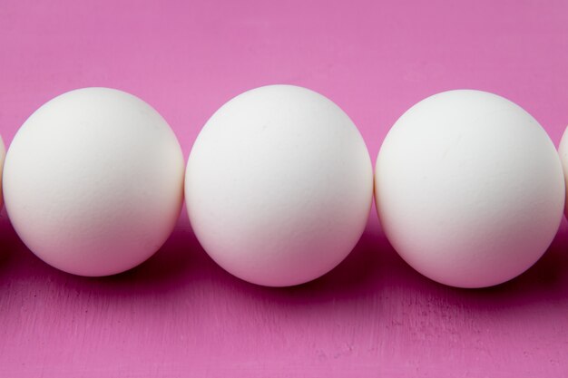 Close-up view of eggs on purple background