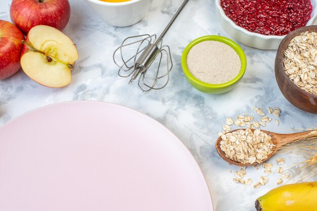 Close up view of empty white plate and fresh healthy food set on two-toned background