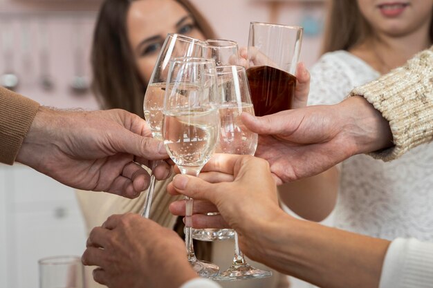 Close-up view of family cheering with champagne