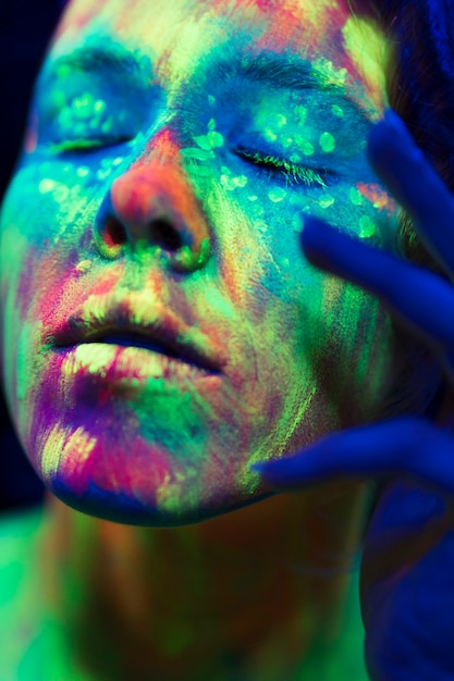 Close-up view of fluorescent make-up on a person