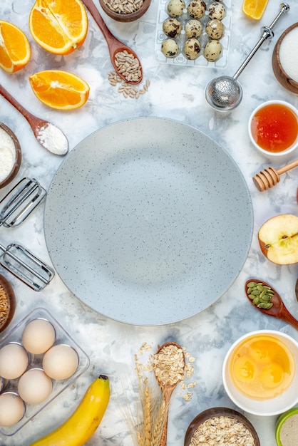 Close up view of gray plate and ingredients for the healthy foods selection on ice background