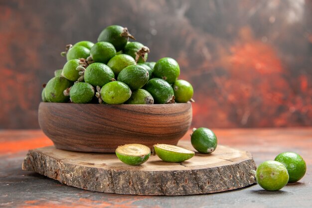 Close up view of green small vitamin bomb fresh feijoas in a brown pot