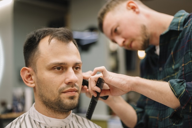 Close-up view of hairstilyst giving a haircut