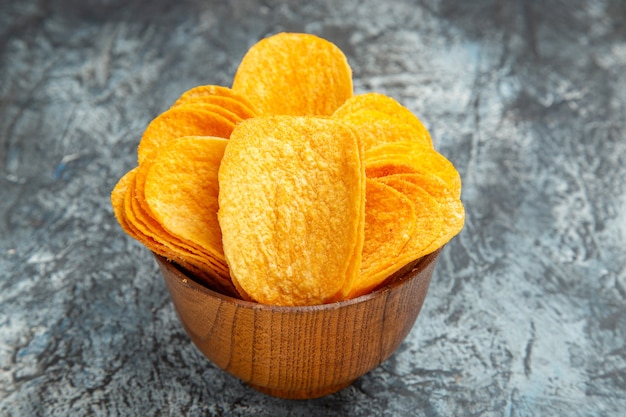 Close up view of homemade delicious crispy chips on gray table stock photo