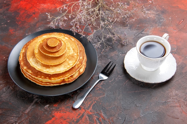 Close up view of homemade pancakes with acup of tea