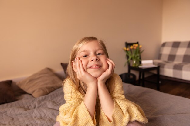 Close up view of little child smile at camera at room