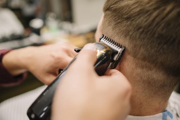 Close-up view of man getting a haircut