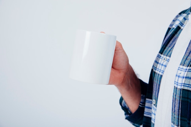 Free photo close up view of man holding mug