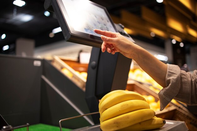 Close up view of measuring weight of fruit at supermarket