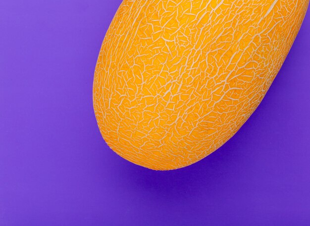 Close-up view of melon on purple background