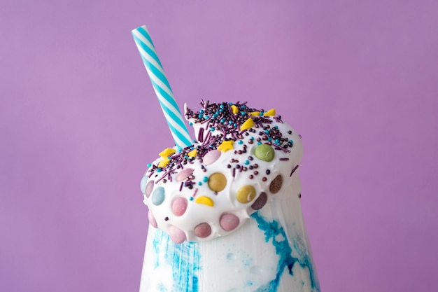 Free photo close-up view of milkshake with purple background