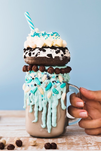 Free photo close-up view of a milkshake  on wooden table