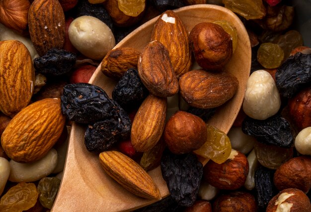 Close up view of mix of nuts and dried fruits almond and black raisins