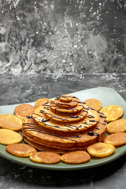 Close up view of pancake decoration on a green plate on gray