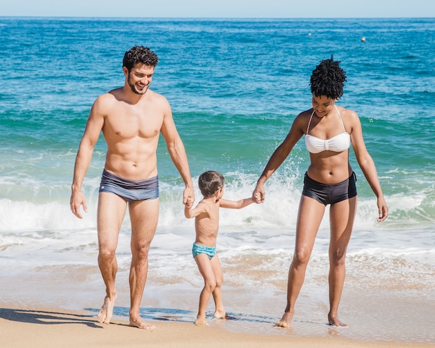 Close up view of parents with son at the beach